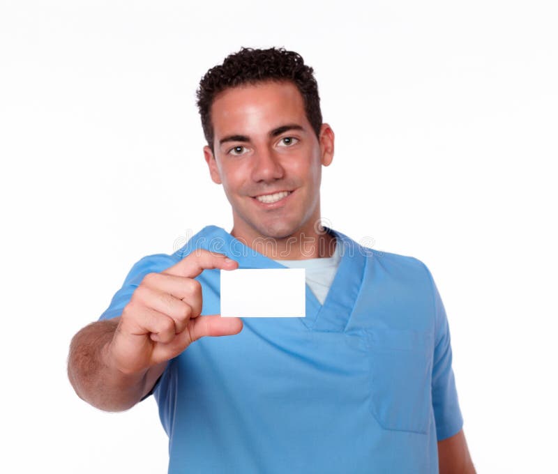 Hombre magnífico de la enfermera que sostiene una tarjeta en blanco foto de archivo libre de regalías Hombre magnífico de la enfermera que sostiene una tarjeta en blanco foto de archivo libre de regalías