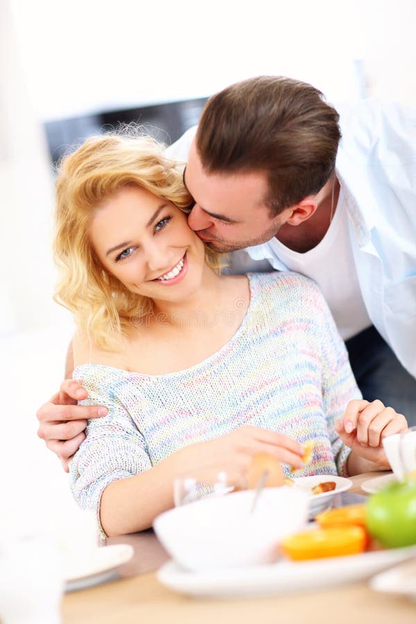 Hombre que da beso de la buena mañana a su esposa imágenes de archivo libres de regalías Hombre que da beso de la buena mañana a su esposa imágenes de archivo libres de regalías