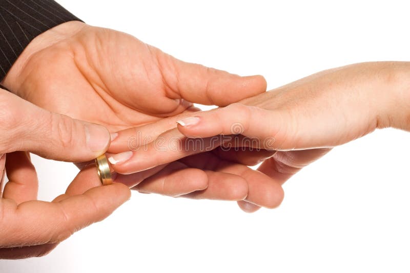 Man hand putting ring on bride's finger. Man hand putting ring on bride's finger