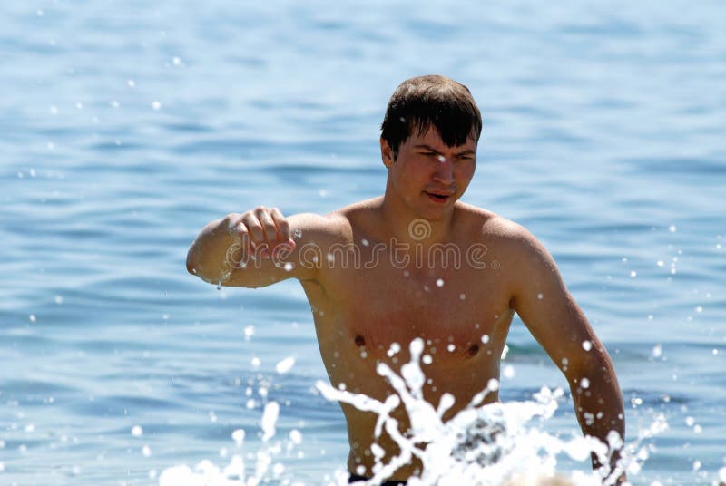 Young guy bathes in sea. Young guy bathes in sea