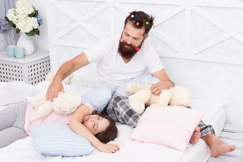 Home day. happy morning together. good night. funny pajama party. small girl with bearded father in bed. weekend at home stock photos Home day. happy morning together. good night. funny pajama party. small girl with bearded father in bed. weekend at home stock photos