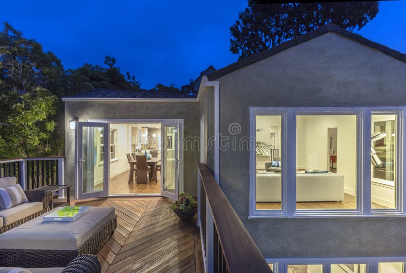 Home with furniture patio / wooden deck at twilight. stock image Home with furniture patio / wooden deck at twilight. stock image