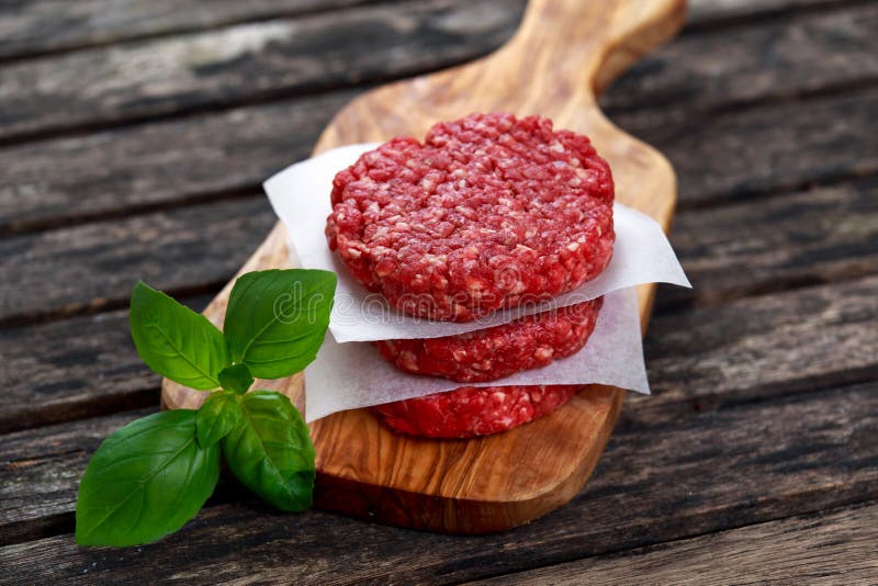 Home HandMade Minced Beef Burgers on Cutting Board. Stock Photo - Image