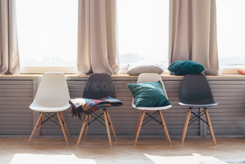 Home Interior. Chairs Arranged in a Row Under Window. Stock Photo