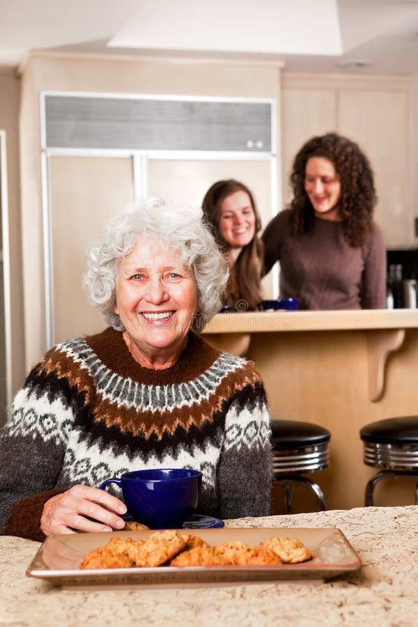 A portrait of a senior lady at home with her daughter and granddaughter. A portrait of a senior lady at home with her daughter and granddaughter