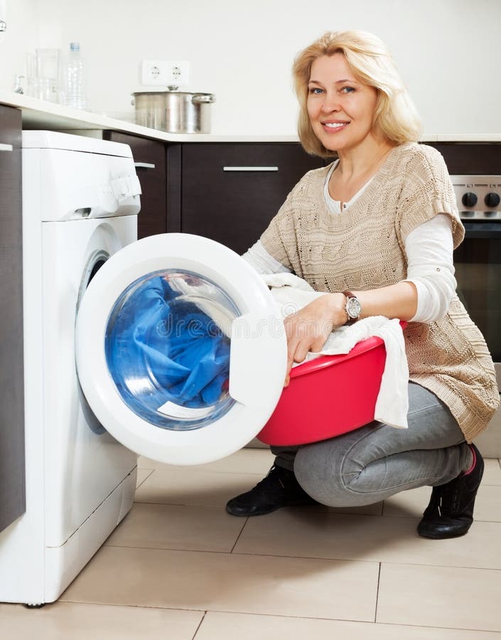 Home Laundry. Housewife Using Washing Machine at Home Stock Photo