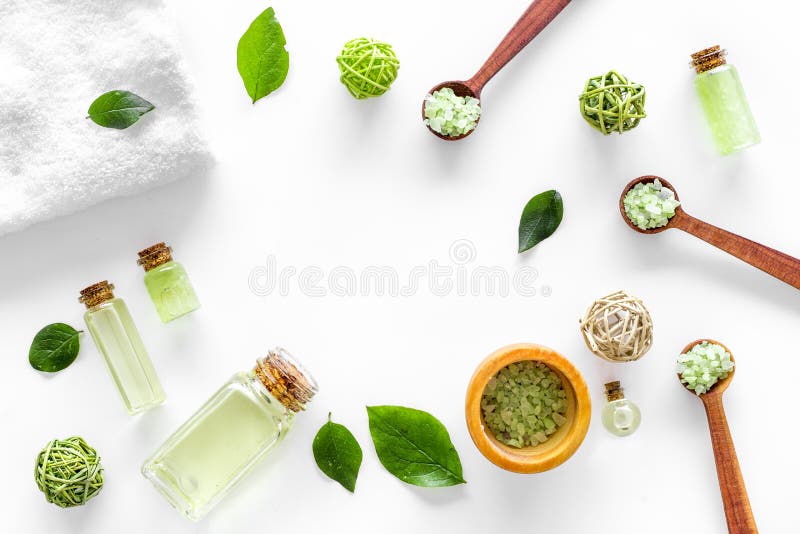 Home made spa cosmetic with tea olive oil and salt for bath on white background top view frame stock photo Home made spa cosmetic with tea olive oil and salt for bath on white background top view frame stock photo
