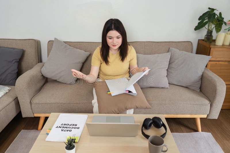 Home Office and Financial Reporting. A young woman discussing insights from her reports during a video call. royalty free stock photography