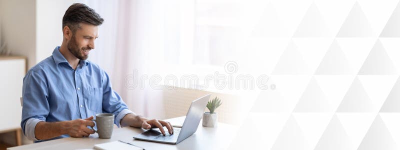 Home Office. Smiling Freelancer Man Checking Emails On Laptop And Drinking Coffee stock photo