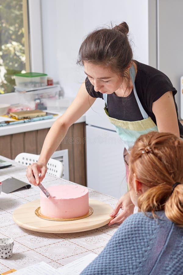 Home pastry chef teaches how to level a cake with cream stock photos Home pastry chef teaches how to level a cake with cream stock photos