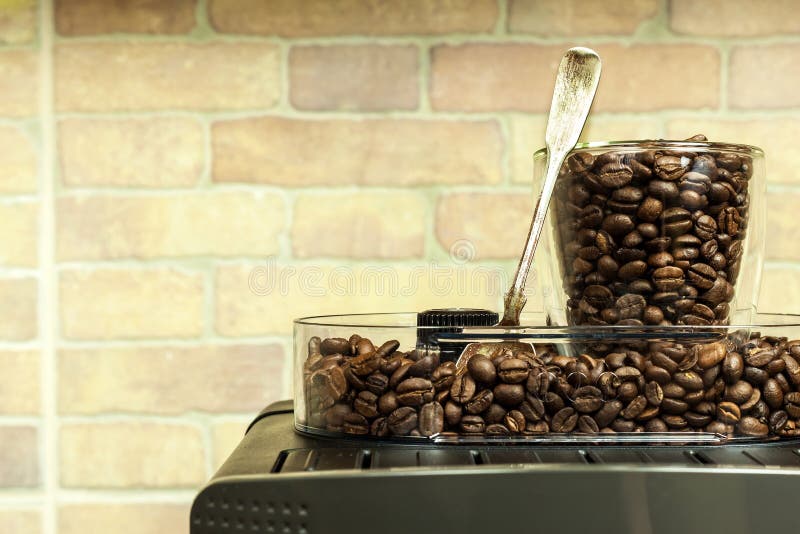 Home professional coffee machine with espresso cup. Coffee preparation. Espresso coffee maker machine and coffee beans stock photo Home professional coffee machine with espresso cup. Coffee preparation. Espresso coffee maker machine and coffee beans stock photo