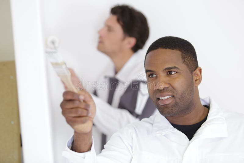 Home Remodeling Concept Team Painters Renovating House Stock Image