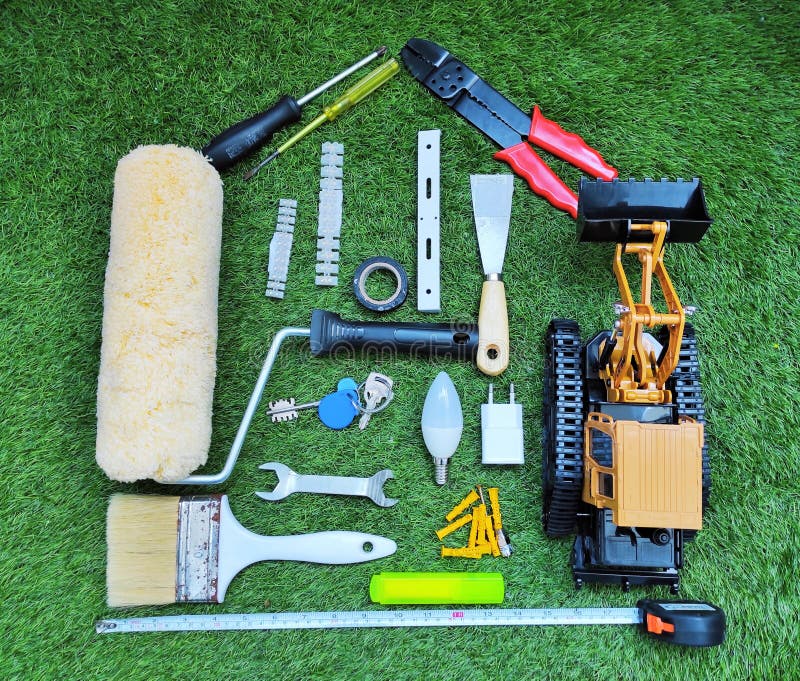 Home Renovation and Construction Concept with Work Tools in House Shape on the Grass Stock Photo