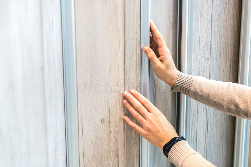Home repair. portrait of woman choosing wood laminated flooring in shop stock images Home repair. portrait of woman choosing wood laminated flooring in shop stock images