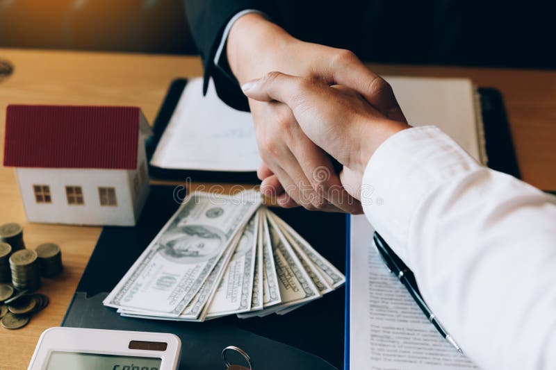 Home sales agents and buyers work on signing new homes and shaking hands royalty free stock images Home sales agents and buyers work on signing new homes and shaking hands royalty free stock images