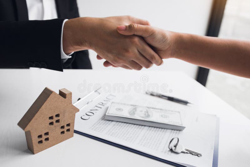 Home sales agents and buyers work on signing new homes and shaking hands royalty free stock photos Home sales agents and buyers work on signing new homes and shaking hands royalty free stock photos