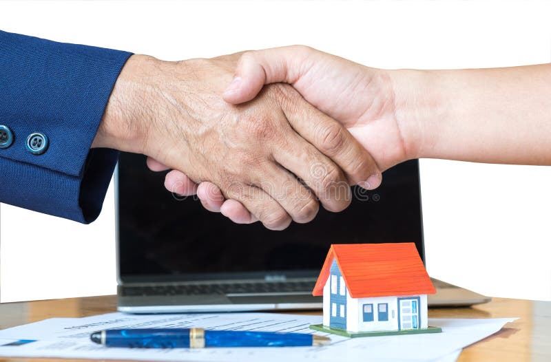 Home salesman shakes hands,Pen and model house on house plan. stock photos Home salesman shakes hands,Pen and model house on house plan. stock photos