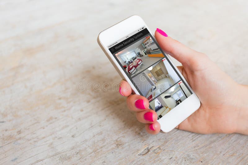 Home security cameras viewed on mobile phone stock photos