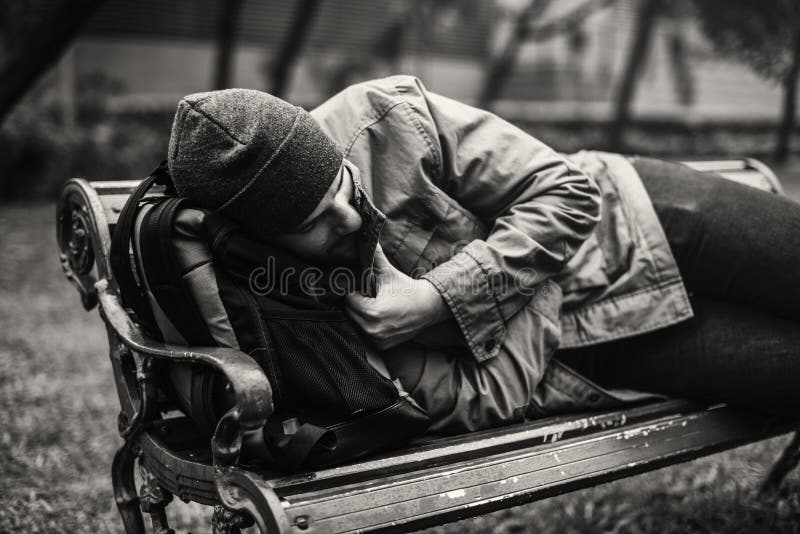 Homeless Adult Man Sleeping on Bench in The Park