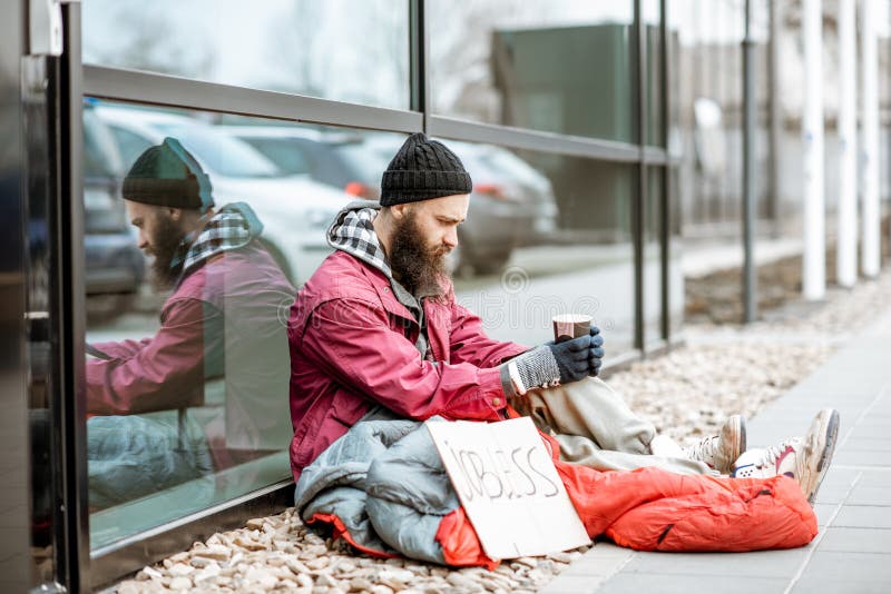 Homeless begging money near the business center