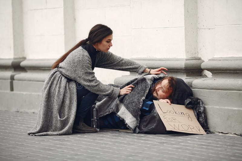 Girl helping a homeless.