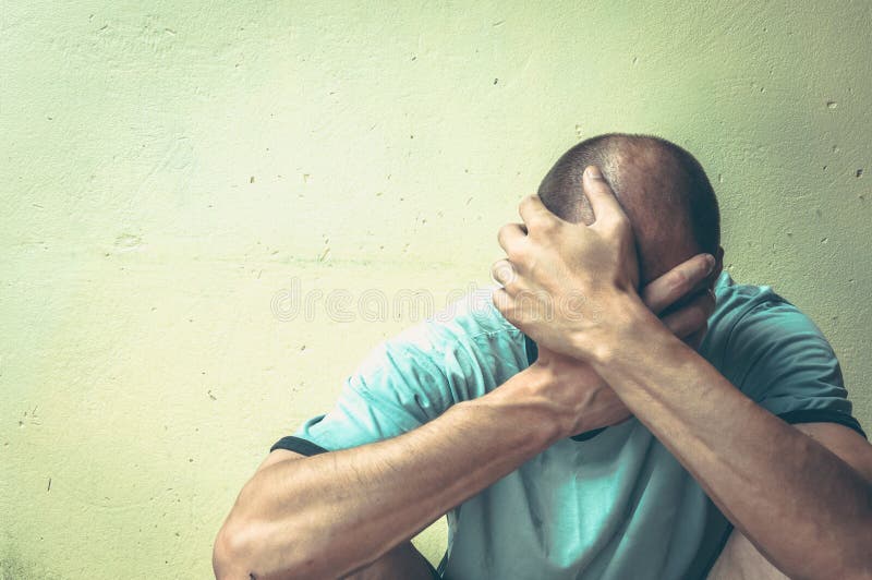 Homeless man drug and alcohol addict sitting alone and depressed on the street in the shadow feeling anxious and lonely, social do stock images Homeless man drug and alcohol addict sitting alone and depressed on the street in the shadow feeling anxious and lonely, social do stock images