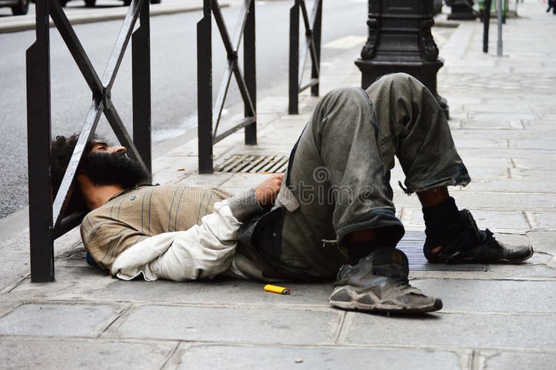 Homeless man sleeping on the street in Paris