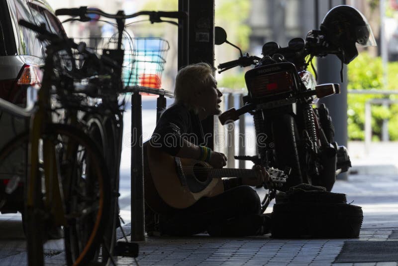 Homeless playing guitar in Tokyo