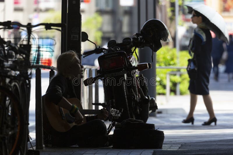 Homeless playing guitar in Tokyo