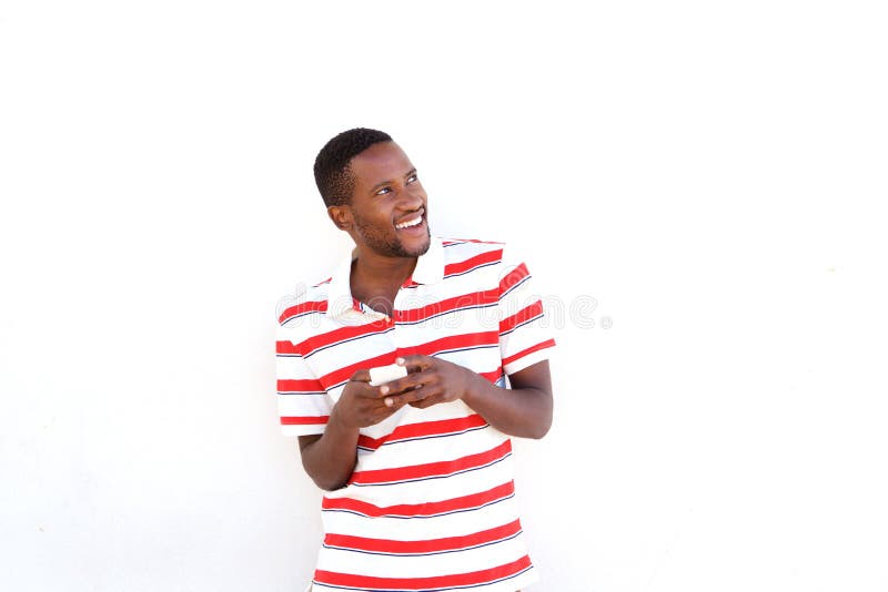 Homem africano novo com o telefone celular que olha afastado imagem de stock Homem africano novo com o telefone celular que olha afastado imagem de stock