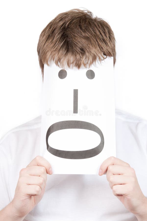 Funny young man with with a smile face drawn on paper isolated on a white background. Funny young man with with a smile face drawn on paper isolated on a white background