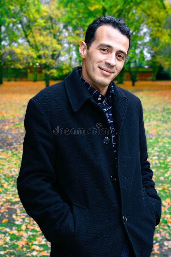 Homem considerável ao ar livre no parque do outono fotografia de stock Homem considerável ao ar livre no parque do outono fotografia de stock