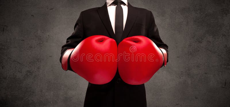 Homem de negócios do encaixotamento na frente do fundo cinzento urbano da parede fotos de stock Homem de negócios do encaixotamento na frente do fundo cinzento urbano da parede fotos de stock
