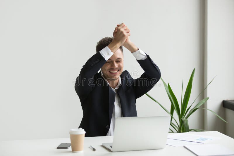 Homem de negócios entusiasmado que comemora a vitória em linha da loteria fotos de stock Homem de negócios entusiasmado que comemora a vitória em linha da loteria fotos de stock