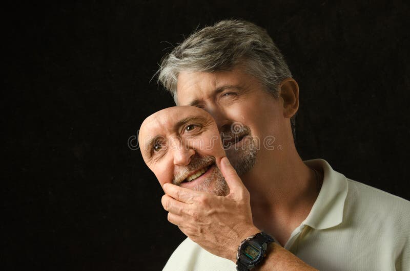 Homem deprimido da doença bipolar com máscara foto de stock Homem deprimido da doença bipolar com máscara foto de stock