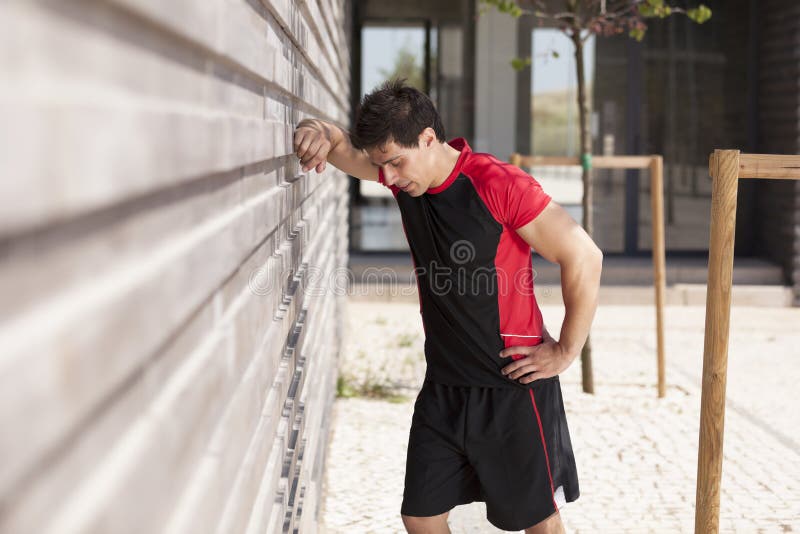 Athlete man tired after a long running sport event in the city. Athlete man tired after a long running sport event in the city