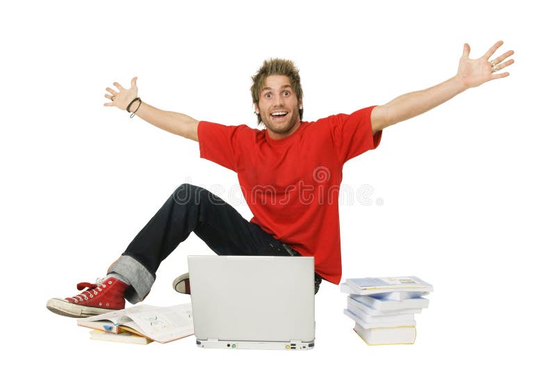 Excited young man with arms raised sitting in front of laptop and stack of books. Excited young man with arms raised sitting in front of laptop and stack of books