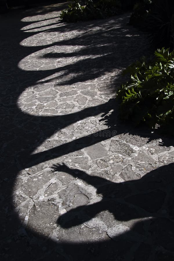 A shadowy picture of a man reaching out, with a pathway and shadowed arches leading out of the frame. A shadowy picture of a man reaching out, with a pathway and shadowed arches leading out of the frame.