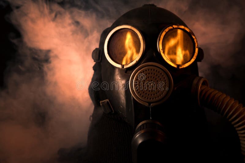 Man in gas mask with fire reflection in the eyes. Man in gas mask with fire reflection in the eyes