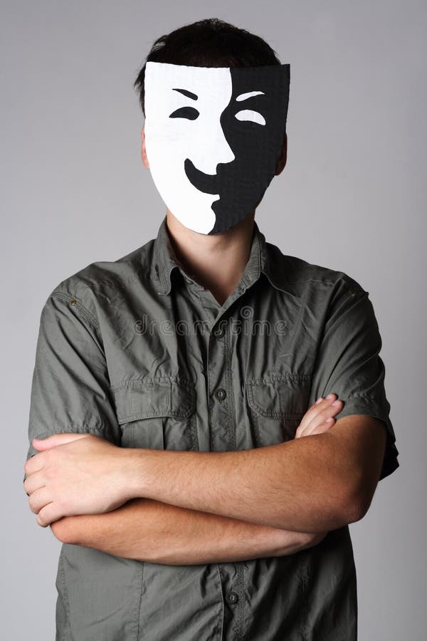 Man in theater black and white smiling mask standing with crossed hands. Man in theater black and white smiling mask standing with crossed hands