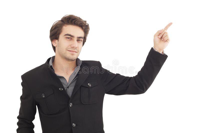 Homem novo considerável que aponta a em algum lugar fotografia de stock Homem novo considerável que aponta a em algum lugar fotografia de stock