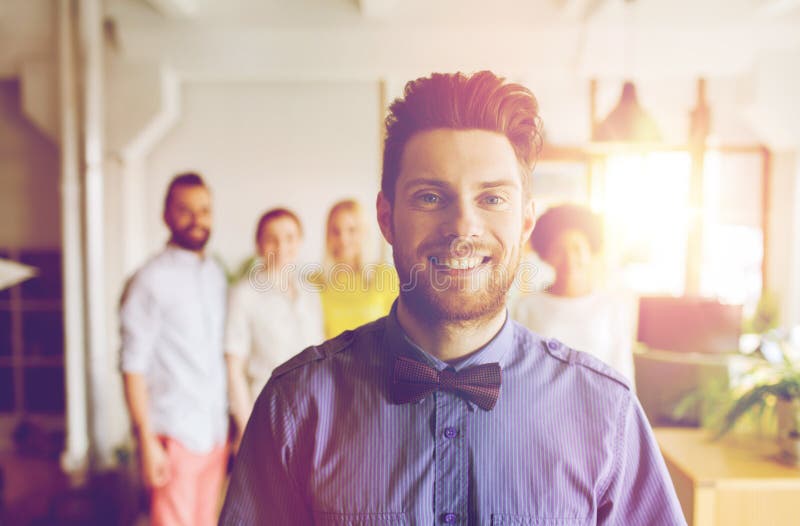 Homem novo feliz sobre a equipe criativa no escritório imagens de stock Homem novo feliz sobre a equipe criativa no escritório imagens de stock