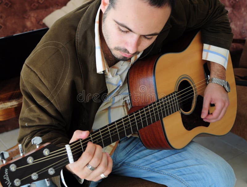 Download Homem Novo Que Joga A Guitarra Imagem de Stock - Imagem de jogar, artista: 16860267