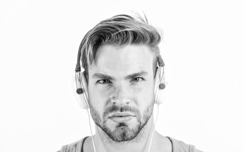 Homem ouvindo música através de seus fones de ouvido som muscular sexy homem em fones de ouvido isolados em branco e livro foto de stock royalty free Homem ouvindo música através de seus fones de ouvido som muscular sexy homem em fones de ouvido isolados em branco e livro foto de stock royalty free