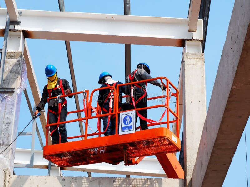 Man Working on the Working at height on blue sky. Man Working on the Working at height on blue sky