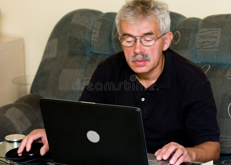 Homem sênior e portátil foto de stock royalty free Homem sênior e portátil foto de stock royalty free