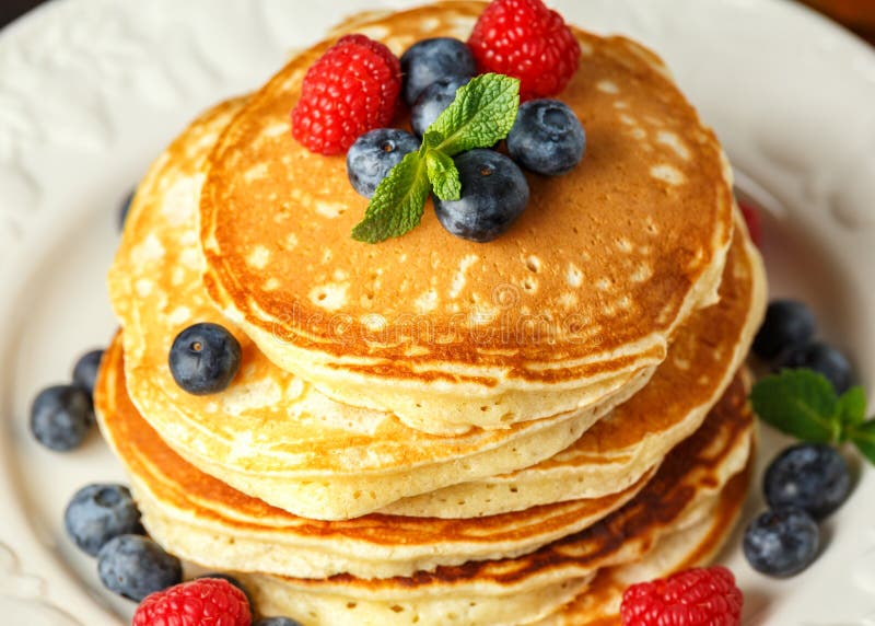 Homemade american blueberry, raspberries pancakes. Healthy morning breakfast. rustic style. royalty free stock image Homemade american blueberry, raspberries pancakes. Healthy morning breakfast. rustic style. royalty free stock image