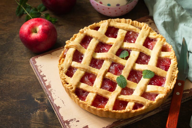 Homemade baking. Sweet apple pie on a rustic wooden table. royalty free stock image