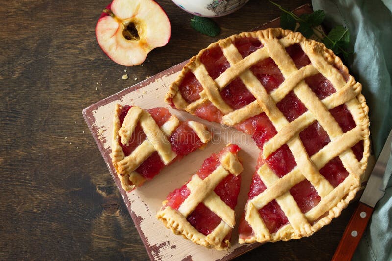 Homemade baking. Sweet apple pie on a rustic wooden table. royalty free stock image