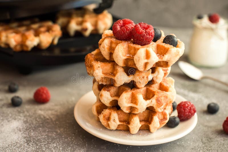 Homemade Belgian waffles with forest fruits, blueberries, raspberries and yogurt. stock photo Homemade Belgian waffles with forest fruits, blueberries, raspberries and yogurt. stock photo